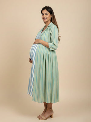 Side pose maternity and nursing outfit with green striped longline shacket over striped maxi dress.