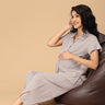 The Mom Store striped maternity and nursing nightwear set seated relaxed pose for cozy pregnancy comfort