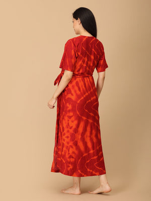 The Mom Store red tie-dye maternity wrap dress back view showing waist tie and ankle length.