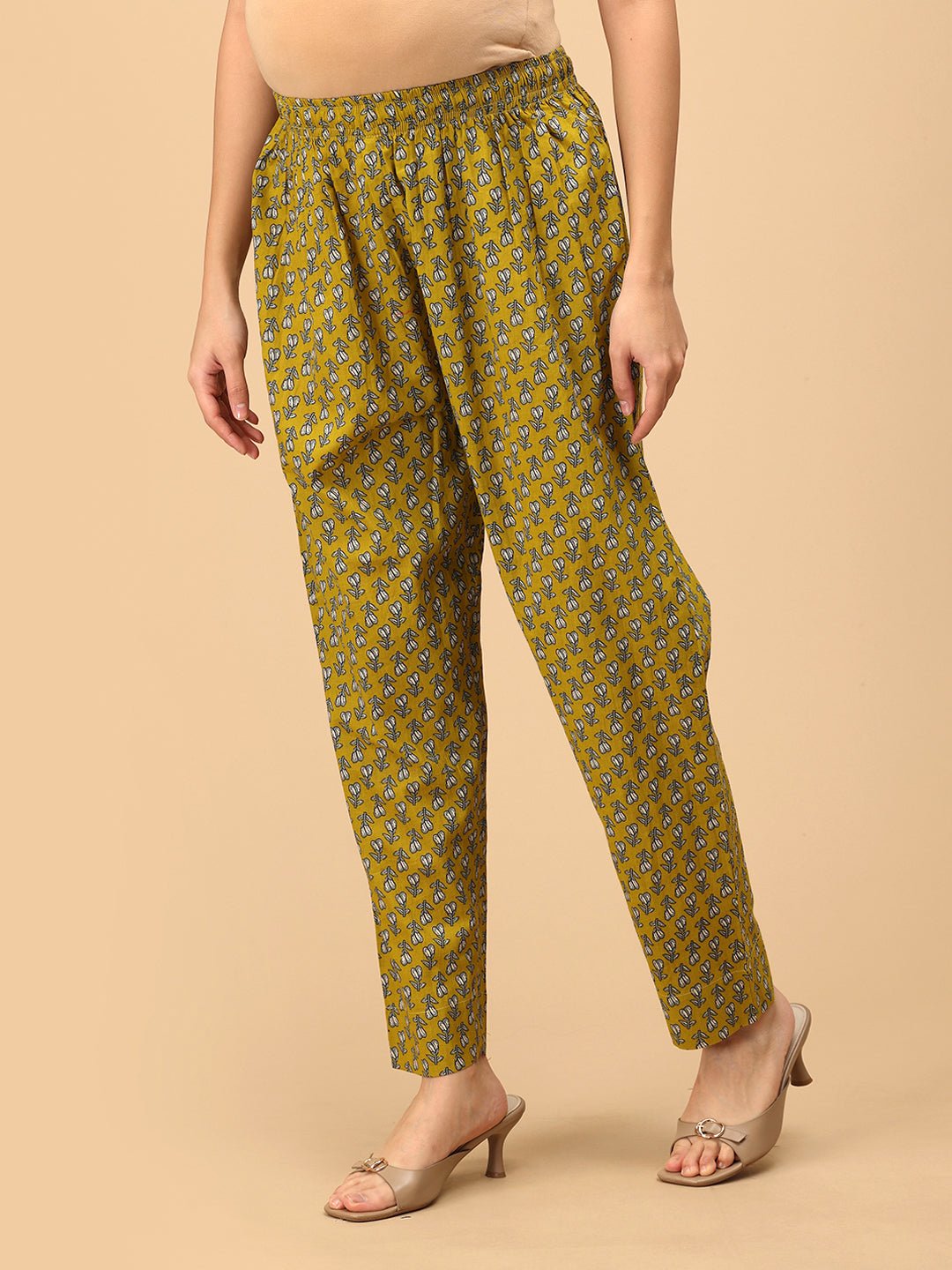 Side angle of Sunehri Blooms yellow printed maternity pants with relaxed straight-leg silhouette.