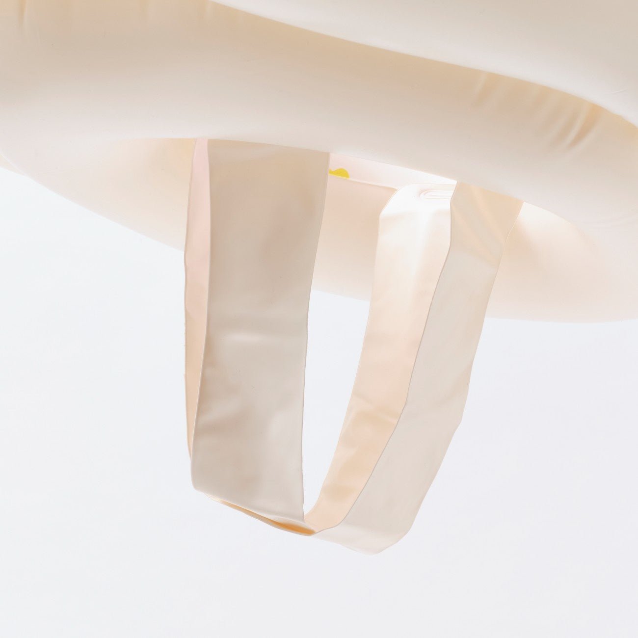 Close-up of a beige fabric with a subtle pattern on a light gray background