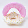 Pink inflatable pool with baby swimming ring on a white background