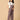 Pregnant woman in The Mom Store taupe corduroy maternity dungaree showing relaxed wide-leg style.