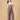 Front pose of pregnant woman in The Mom Store taupe corduroy maternity dungaree with pockets.