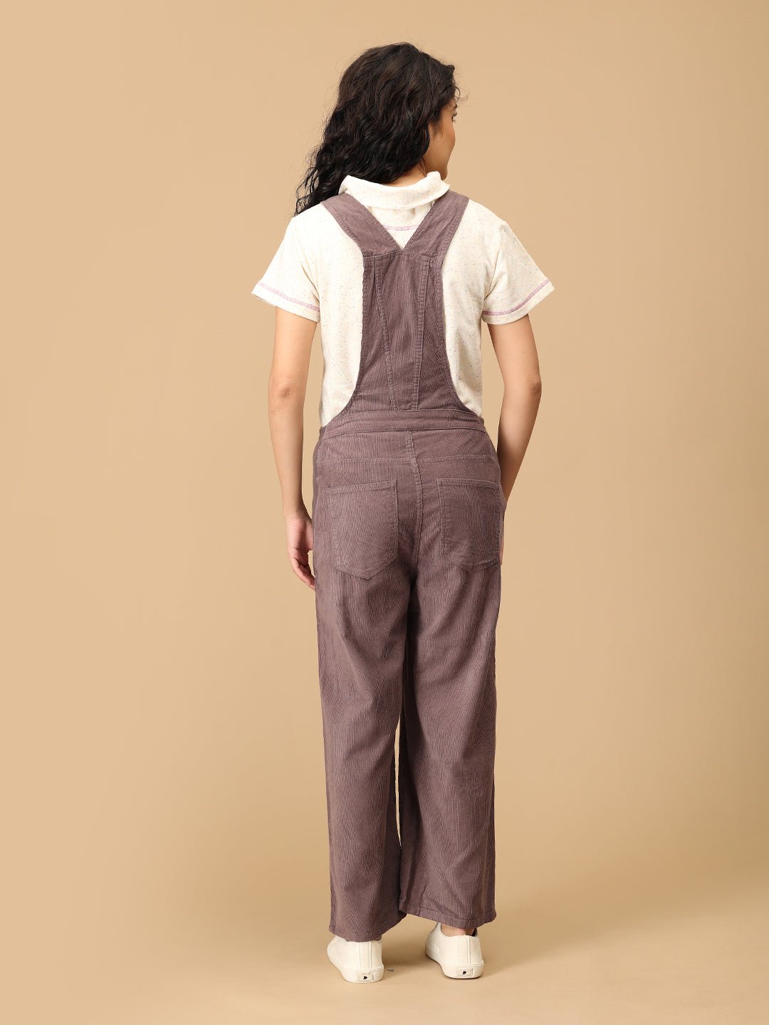 Back view of The Mom Store taupe corduroy maternity dungaree with cross-back straps and pockets.