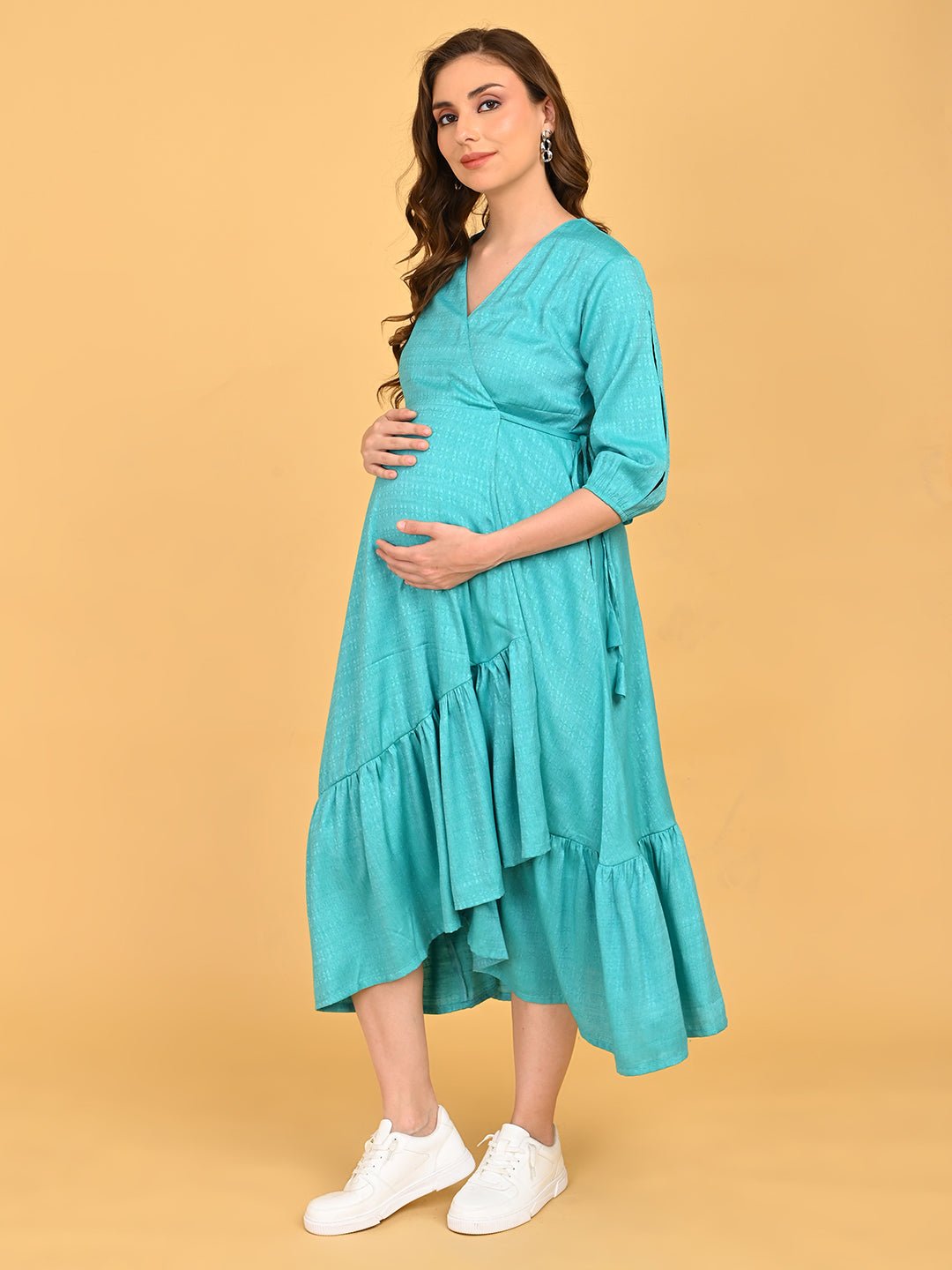 Turquoise Temptation Maternity Wrap Dress side profile view emphasizing bump-friendly wrap silhouette and layered skirt.