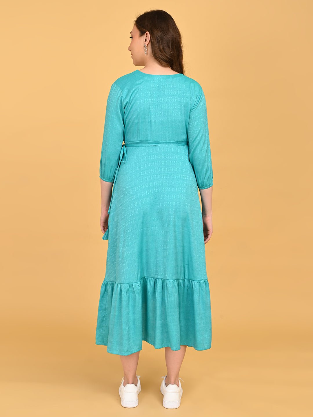 Turquoise Temptation Maternity Wrap Dress back view showing relaxed fit, waist tie detail, and midi-length ruffle hem.