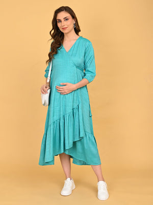 Turquoise Temptation Maternity Wrap Dress angled front view highlighting asymmetrical layered ruffle hem and flowy silhouette.