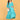 Turquoise Temptation Maternity Wrap Dress full-length front pose with model cradling bump, showcasing textured fabric and wrap design.