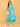 Turquoise Temptation Maternity Wrap Dress full-length front pose with model cradling bump, showcasing textured fabric and wrap design.