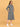 Three-quarter angle view of Undercover Cozy maternity hoodie dress showing curved seam lines and side pockets.