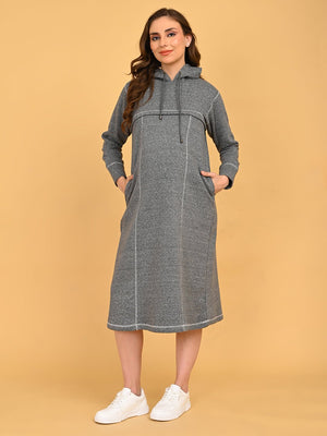 Pregnant model standing comfortably in grey maternity hoodie dress with relaxed knee-length silhouette.