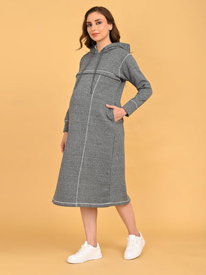 Pregnant model wearing Undercover Cozy grey maternity and nursing hoodie dress with side pockets and white sneakers.