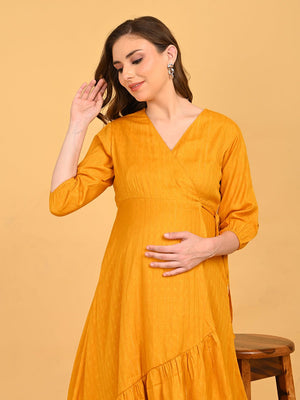 Close up of playful pose with model in yellow go go maternity wrap dress